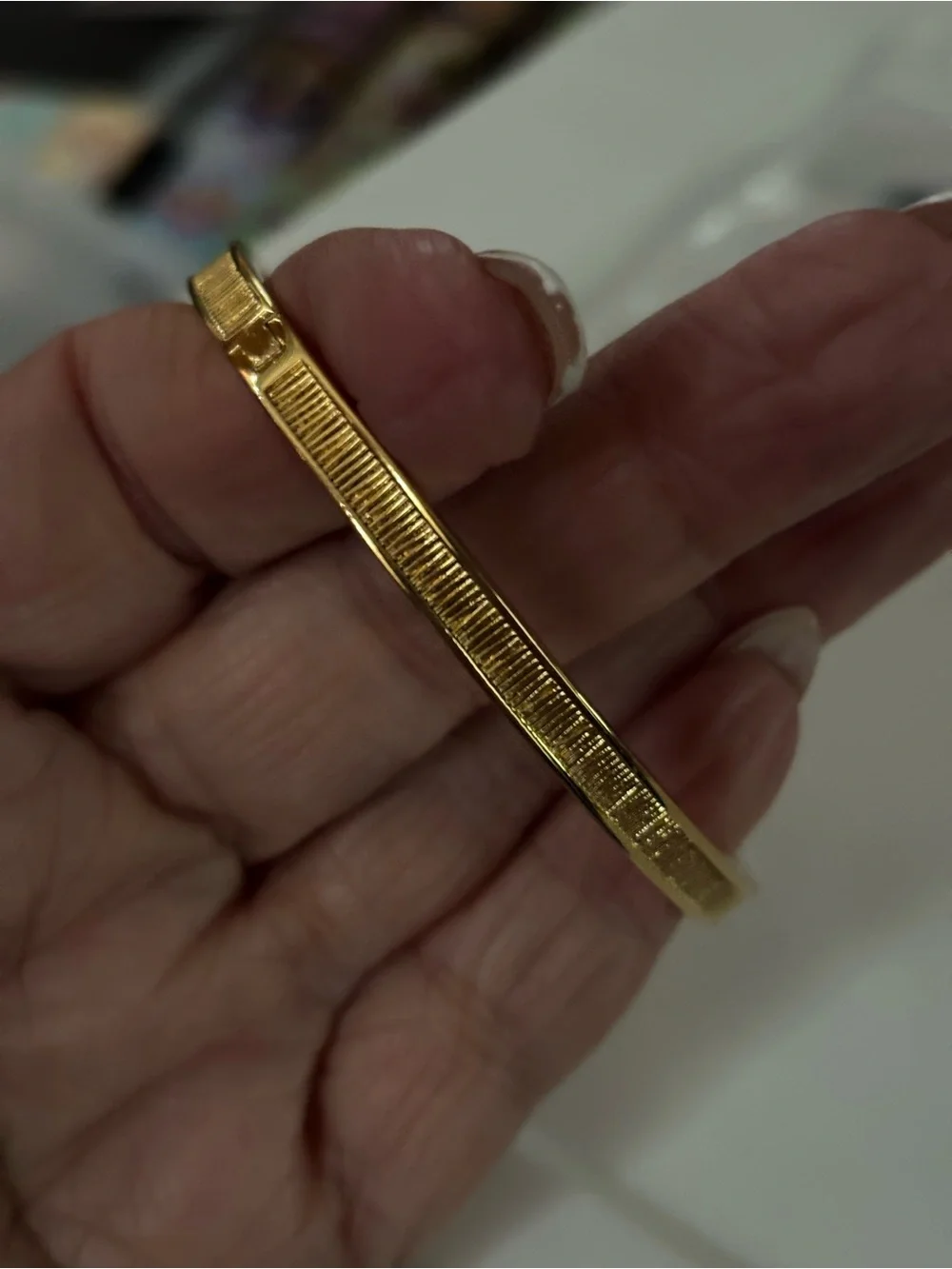 Coach Gold-Tone Textured Bangle with Star Crystal Accent Rexy